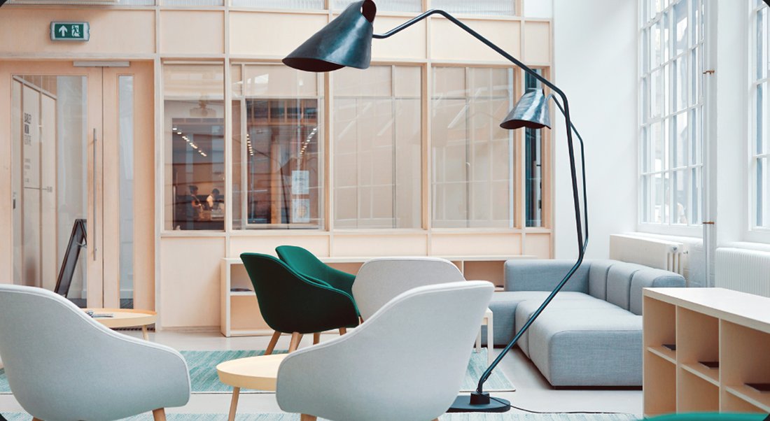A bright living room with armchairs and an arched floor lamp, the cover of a saved interior-design card